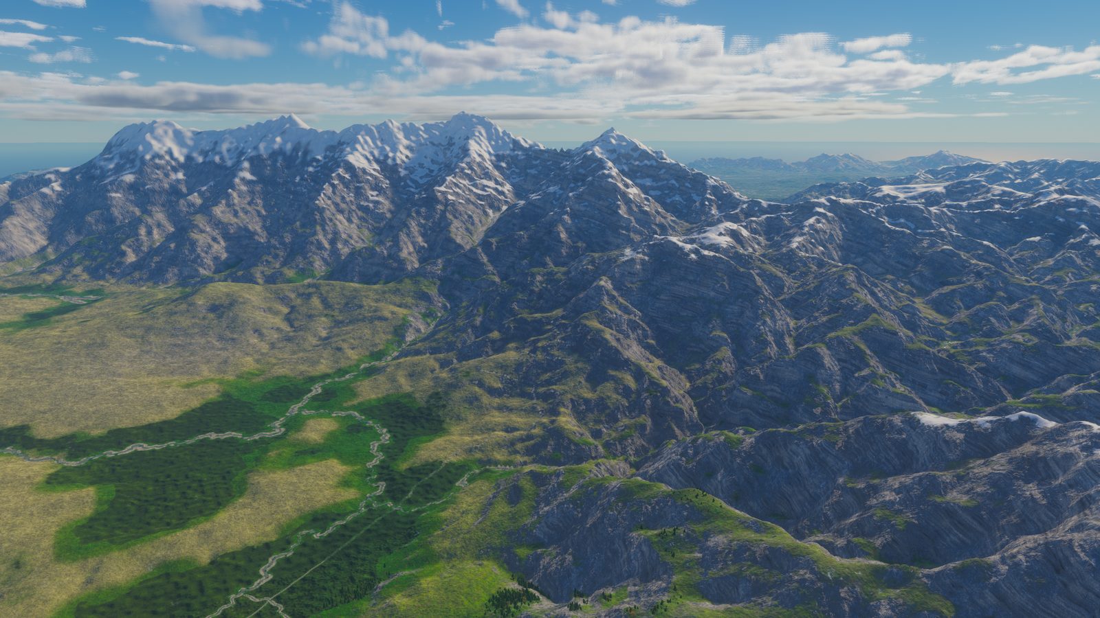 Snow-capped range above forested lowland