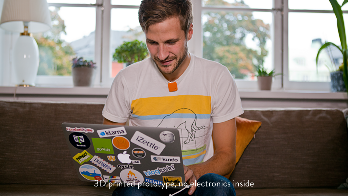 One of the co-founders, Oskar Kalmaru, wearing the Memoto Orange prototype