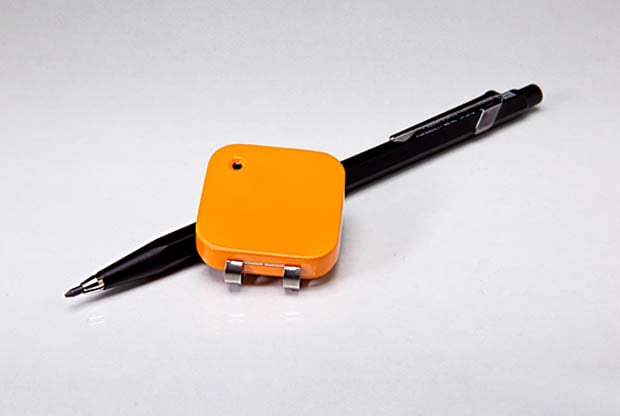 Memoto camera next to a pencil for size comparison